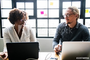 Business people working on laptops during a meeting