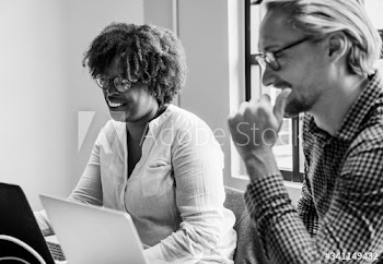 Business people working on laptops during a meeting
