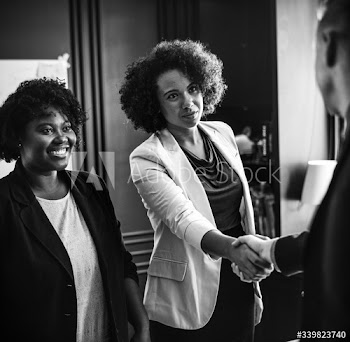 Business person greeted by a handshake