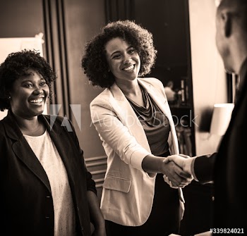 Business person greeted by a handshake
