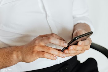 Businessman checking his social media account and messages on a phone | Free  photo - 2353090