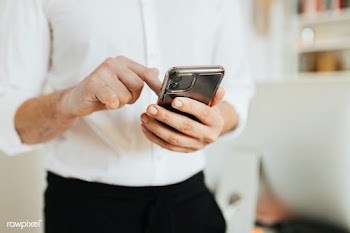 Businessman checking his social media account and messages on a phone | Free  photo - 2353112