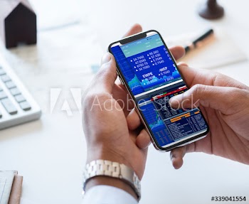 Businessman checking stock market from his phone