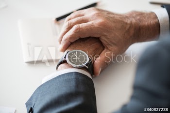 Businessman checking time on hand watch