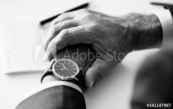 Businessman checking time on hand watch