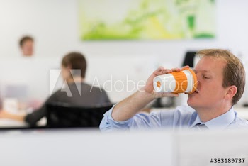 Businessman drinking coffee in office