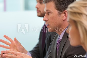 Businessman gesturing and explaining in meeting