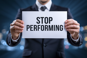 Businessman Holding 'STOP PERFORMING' Sign