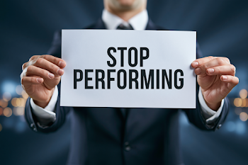 Businessman Holding 'Stop Performing' Sign