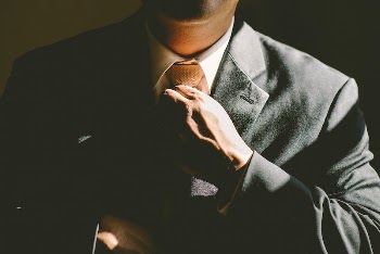 Businessman in black suit loosening | Free Photo - rawpixel