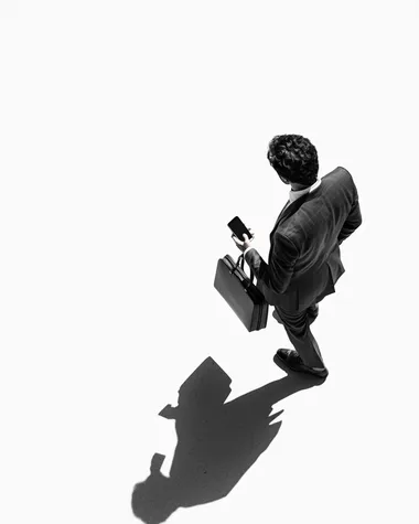 Businessman in Suit Walking with Briefcase and Phone, Overhead Shot