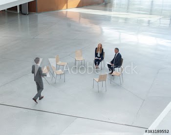 Businessman joining colleagues meeting in circle