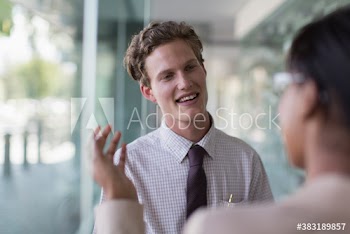 Businessman listening to colleague in office