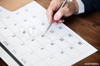 Businessman marking on calendar for an appointment