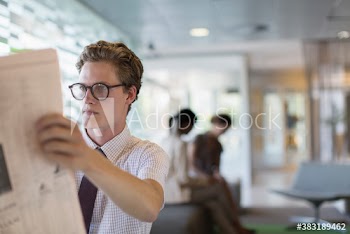 Businessman reading newspaper