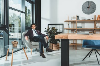 Businessman sitting in armchair in office