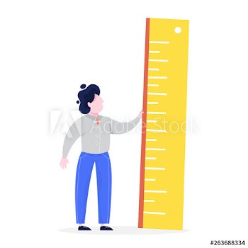 Businessman standing and holding a big ruler