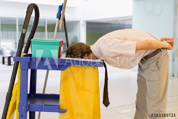 Businessman sticking head in trash