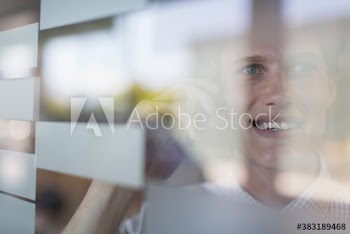 Businessman talking on smart phone at window
