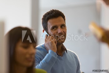 Businessman talking on smart phone in office