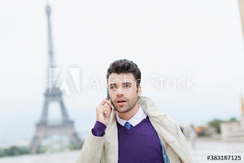 Businessman talking on smart phone near Eiffel Tower, Paris, France