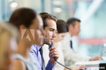 Businessman talking on telephone in office