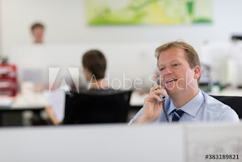 Businessman talking on telephone in office