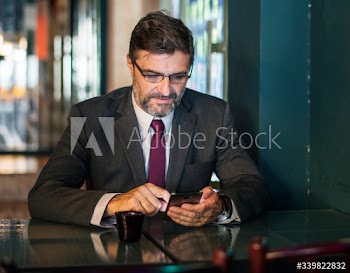 Businessman texting on his mobile phone
