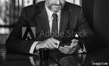 Businessman texting on his mobile phone
