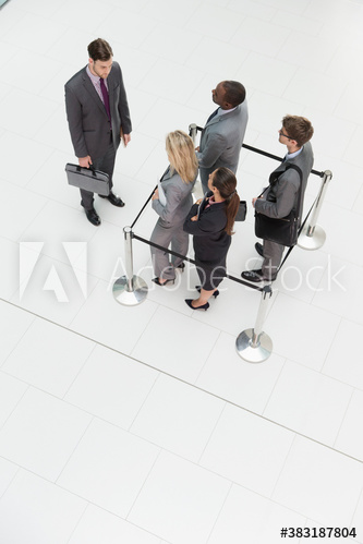 Businessman watching business people trapped in square stanchions