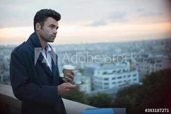 Businessman with coffee and smart phone, Montmartre, Paris, France