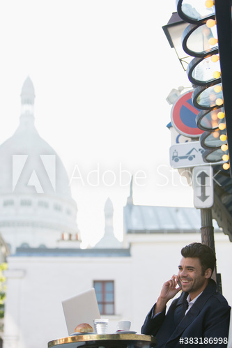 Businessman working at sidewalk cafe, Montmartre, Paris, France