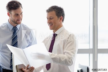 Businessmen discussing paperwork in meeting