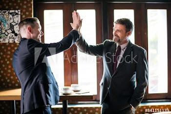 Businessmen giving a high five