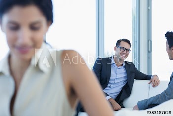 Businessmen talking on sofa