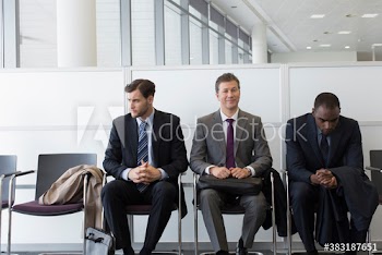 Businessmen waiting for job interview in office lobby