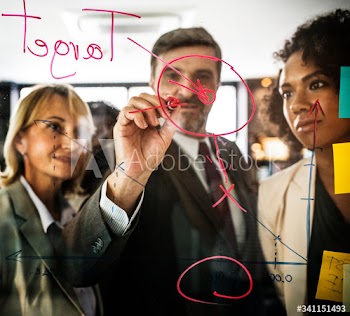 Businesspeople planning on a glass wall
