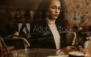Businesswoman at cafe working on laptop