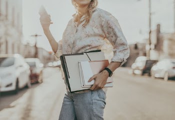 Businesswoman crossing a street while | Free Photo - rawpixel