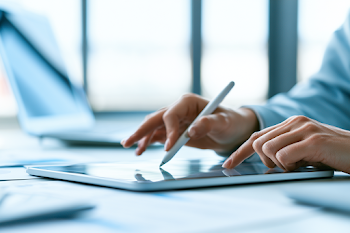 Businesswoman Digitally Signing Contract on Tablet