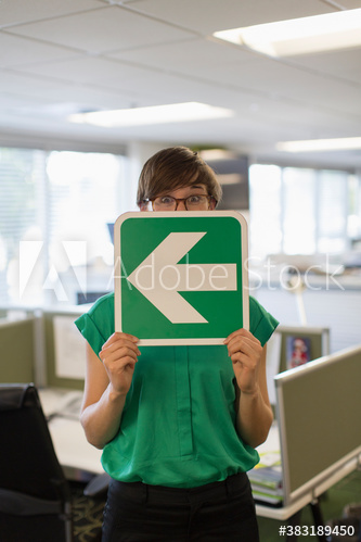 Businesswoman holding arrow sign
