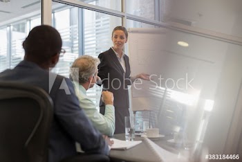 Businesswoman leading conference room meeting