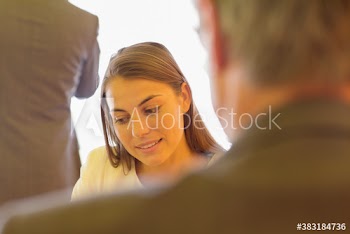 Businesswoman looking down in conference room meeting