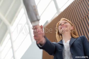 Businesswoman shaking hands with colleague