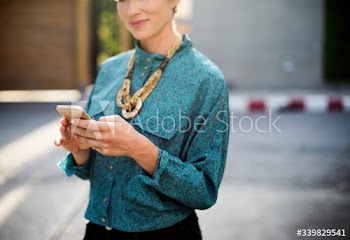 Businesswoman standing and using mobile phone