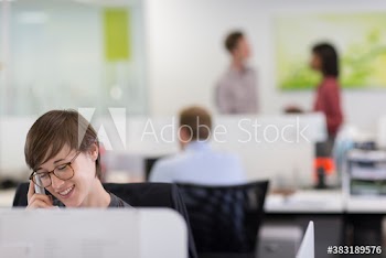 Businesswoman talking on telephone in office