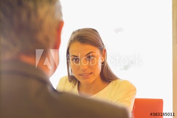 Businesswoman talking with colleague in conference room meeting