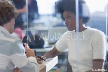 Businesswoman talking with colleague in office