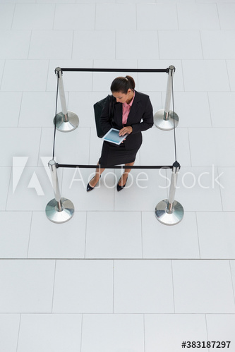 Businesswoman trapped in square stanchions
