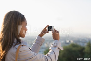 Businesswoman using camera phone